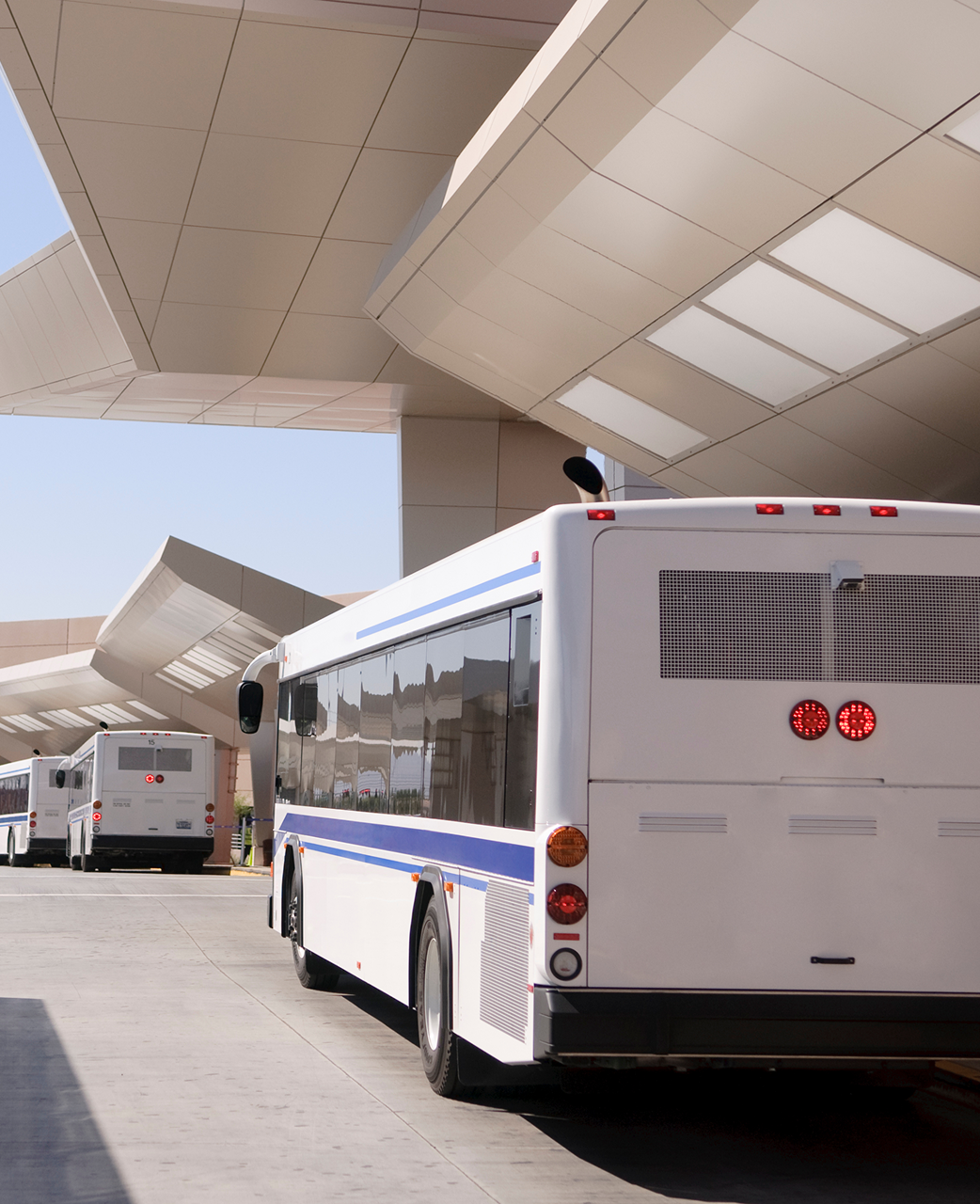 White buses in a station terminal